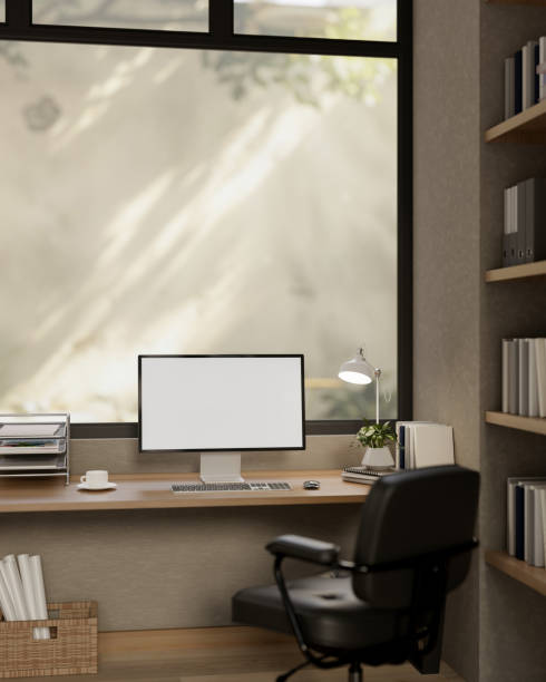 istock A comfortable, minimalist office featuring a computer with a white screen mockup on a wooden desk. 2191137046