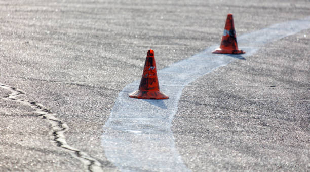 istock Two orange cones are on a road, with a white line in between them 2191137229