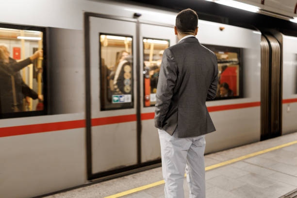 istock Businessman waiting for train on subway station 2191137245