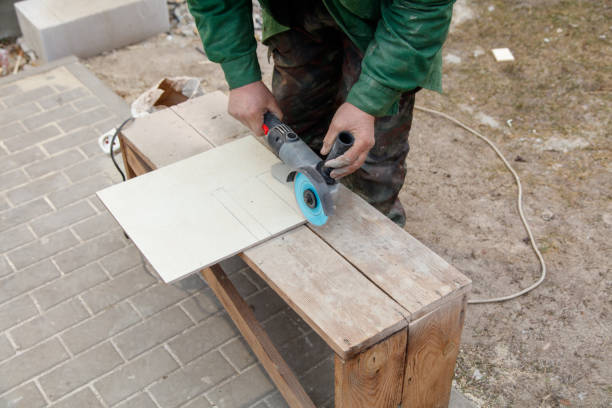 A man is using a power tool to cut a piece of wood. Concept of hard work and determination as the man focuses on his task. The use of a power tool suggests that the man is skilled