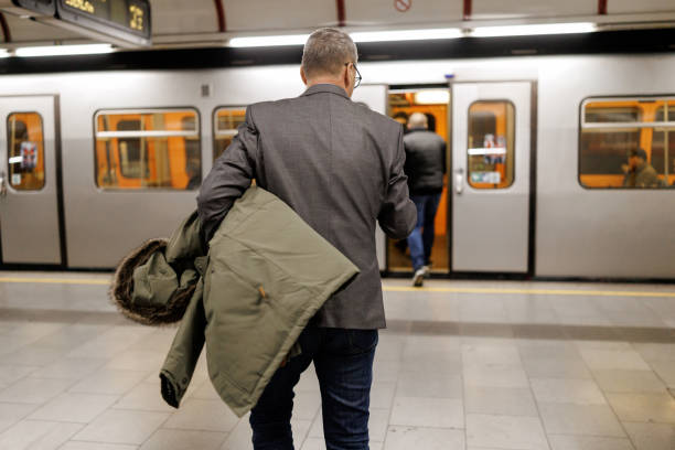 istock Businessman walking to enter the  train on subway station 2191137771