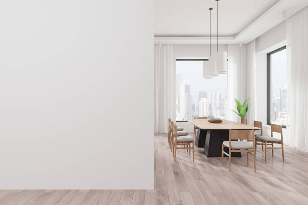istock Modern dining room with blank wall and large windows overlooking city through curtains. 3D Rendering 2191140482