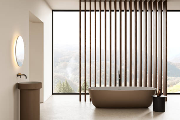 istock Beige home bathroom interior with sink and tub, slats and panoramic window 2191140665