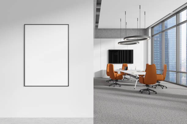 istock Light office interior with meeting table and tv screen, window and mockup frame 2191140951