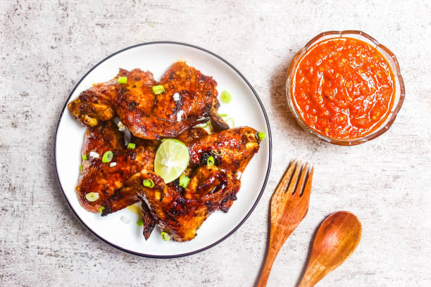 istock Grilled chicken wings in a plate with chili sauce 2191141768
