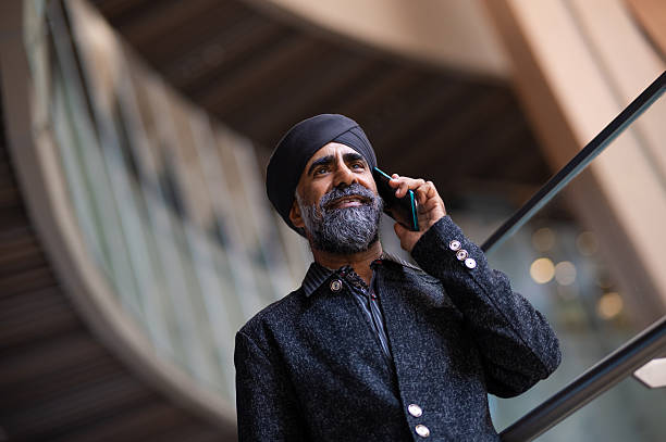 istock Sikh businessman talking on smartphone 2191141795