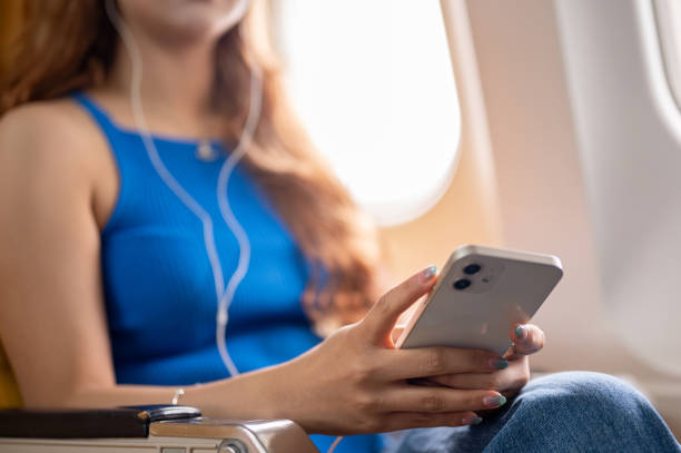 istock A close-up of a female passenger using her smartphone during the flight. 2191142764