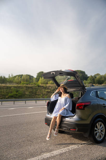 istock Woman Enjoying a Sunny Day by Her Car 2191143648