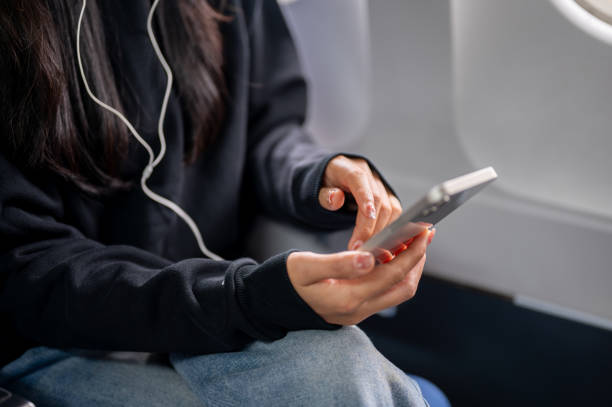 istock A close-up of a female passenger using her smartphone during the flight. 2191144423