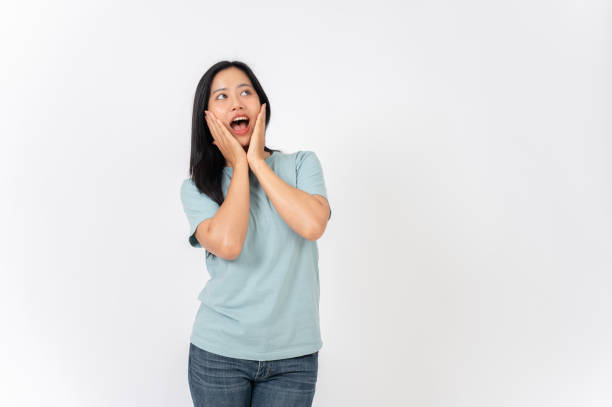 istock An excited Asian woman on a studio background with a surprising face expression. wow, amazed 2191146390