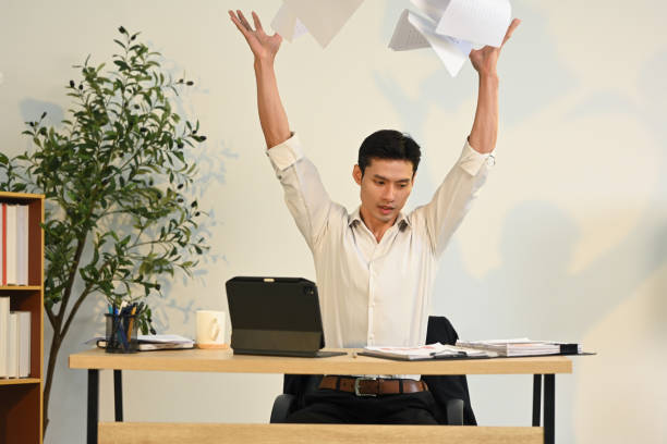 istock Frustrated businessman throwing documents in anger. Stress at work concept 2191148494