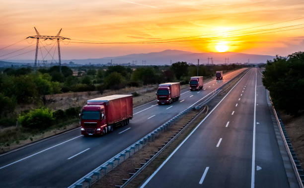 istock Red Transportation trucks traveling on sunset 2191148752