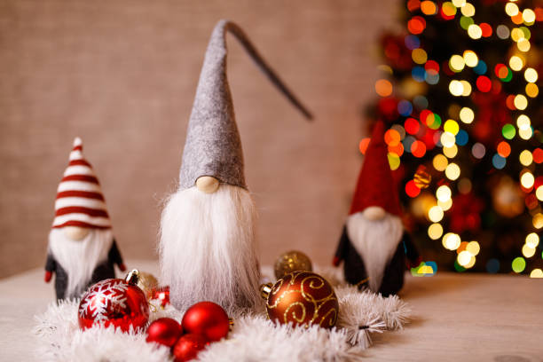 istock Festive Christmas Gnome Decorations with Ornaments and Bokeh Christmas Tree in Background 2191150496