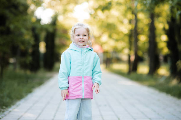 istock Kid girl wearing jacket outdoor 2191151631