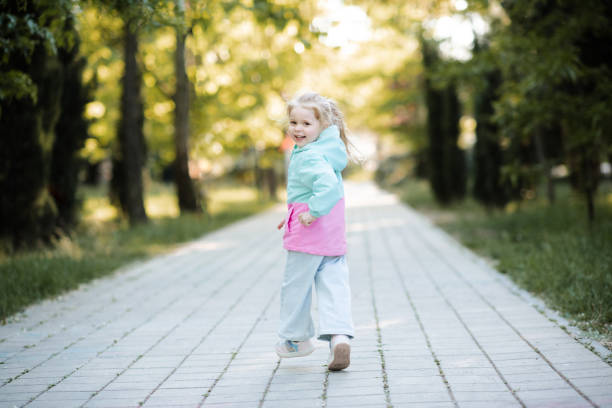 istock Kid girl wearing jacket outdoor 2191151656