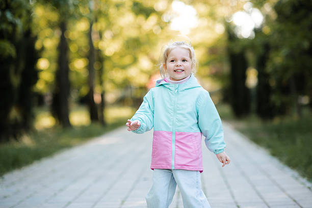 istock Kid girl wearing jacket outdoor 2191151657