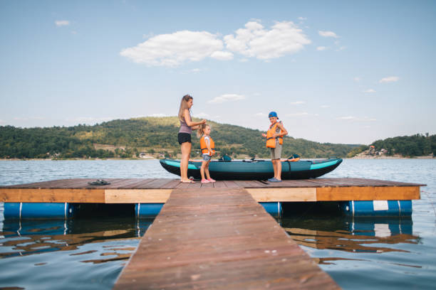Family preparing for lake kayak ride.