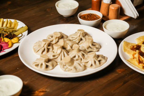 istock Dumplings served on a plate with various accompaniments at a restaurant 2191152762