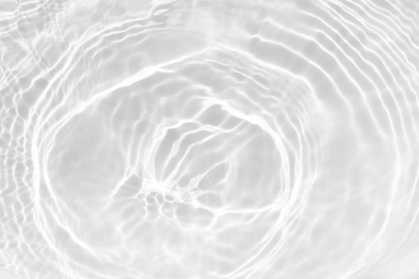 istock White water with ripples on the surface. Defocus blurred transparent blue colored clear calm water surface texture with splashes and bubbles. Water waves with shining pattern texture background. 2191153827