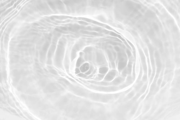 istock Gray water with ripples on the surface. Defocus blurred transparent blue colored clear calm water surface texture with splashes and bubbles. Water waves with shining pattern texture background. 2191153956