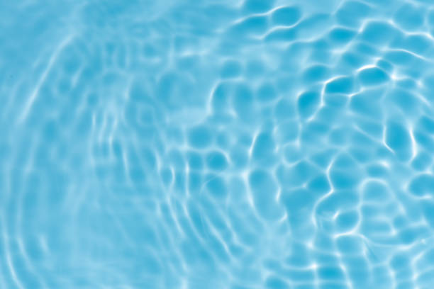 istock Blue water with ripples on the surface. Defocus blurred transparent blue colored clear calm water surface texture with splashes and bubbles. Water waves with shining pattern texture background. 2191154062