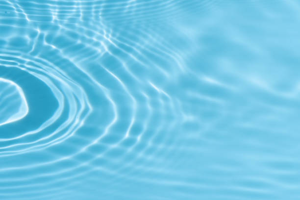 istock Blue water with ripples on the surface. Defocus blurred transparent blue colored clear calm water surface texture with splashes and bubbles. Water waves with shining pattern texture background. 2191154170