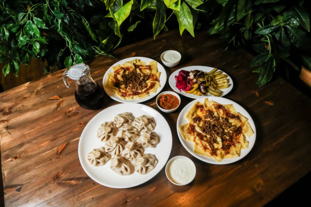 istock Delicious dumplings and flatbreads served on a wooden table 2191154227