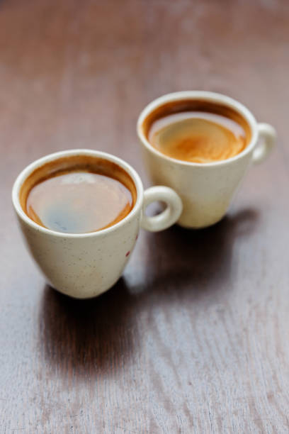 istock Beige ceramic cups filled with espresso on the table 2191154803