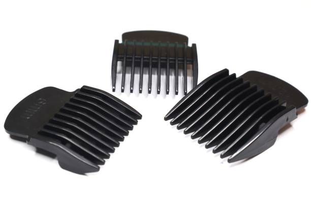 istock Several hair clipper guards of varying lengths are arranged on a white surface. 2191155438
