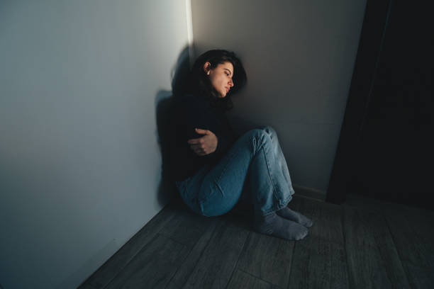 istock Sad lonely woman sitting on the floor at home looking dissociated. 2191157166