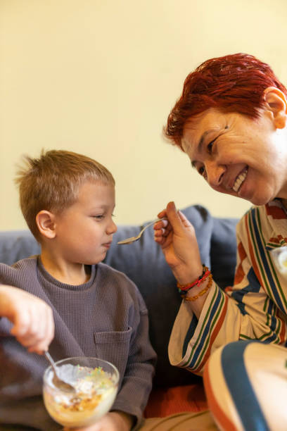 istock A grandmother feeds her grandson with ice cream 2191159346