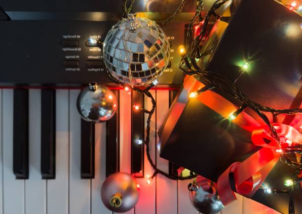 istock Piano keyboard and Christmas pine tree illuminations. Vibrant colors, Holidays concept 2191159622