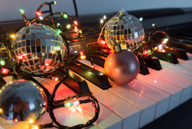 istock Piano keyboard and Christmas pine tree illuminations. Vibrant colors, Holidays concept 2191159746