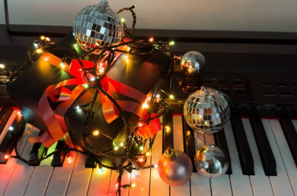 istock Piano keyboard and Christmas pine tree illuminations. Vibrant colors, Holidays concept 2191159802