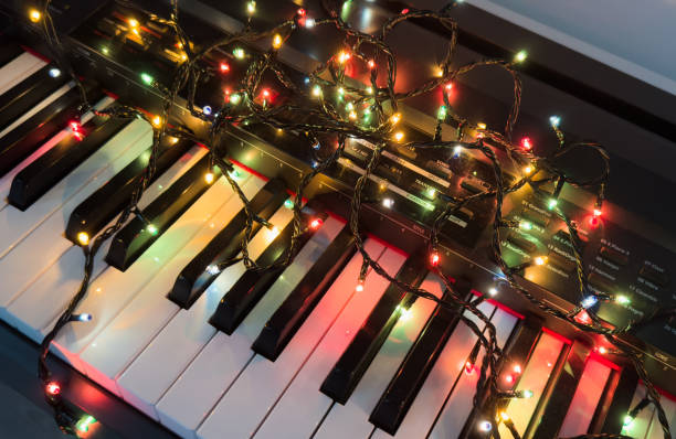 istock Piano keyboard and Christmas pine tree illuminations. Vibrant colors, Holidays concept 2191159854
