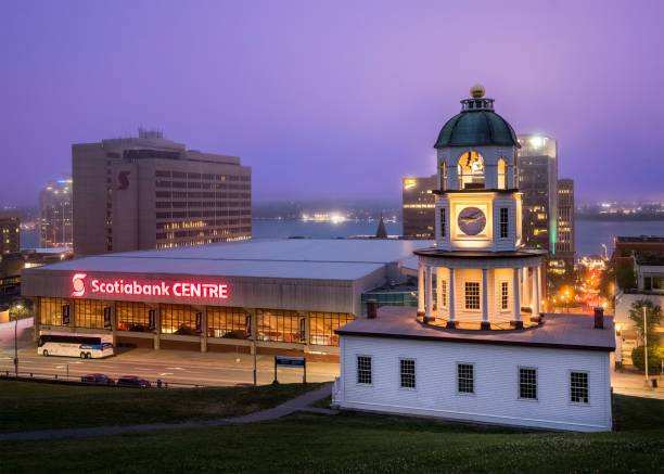 Halifax, Canada – July 25, 2022: Night view of Halifax with the iconic Town Clock and Scotiabank Centre illuminated, showcasing urban architecture and city lights.
