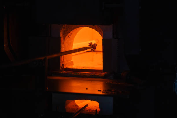 istock Open furnace with molten glass on a  blowpipe inside 2191161305