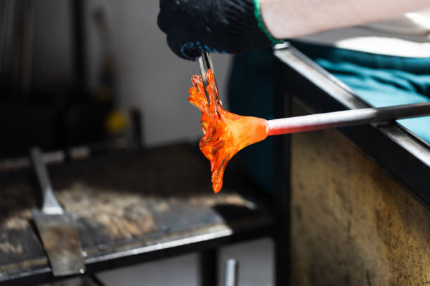 istock Molding molten glass into a flower shape, glass blowing workshop 2191161334
