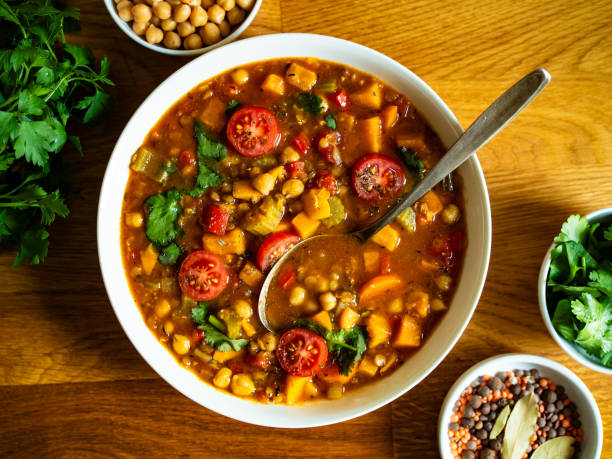 istock Fresh vegetable soup with lentil served in white bowl on wooden table 2191165355