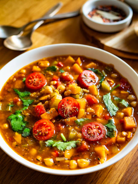 istock Fresh vegetable soup with lentil served in white bowl on wooden table 2191165375