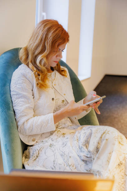 istock Businesswoman sitting and using phone app to prepare for work 2191165384