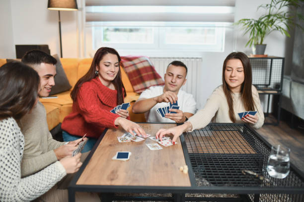 istock Females Taking Cards From Table Competing in Fun Card Game 2191168968