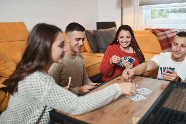 istock Fun Card Game Night Between Friends Sitting on Ground Competing 2191169172