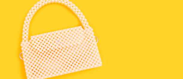 istock Handbag made from pearl imitation beads on a yellow background. 2191171781