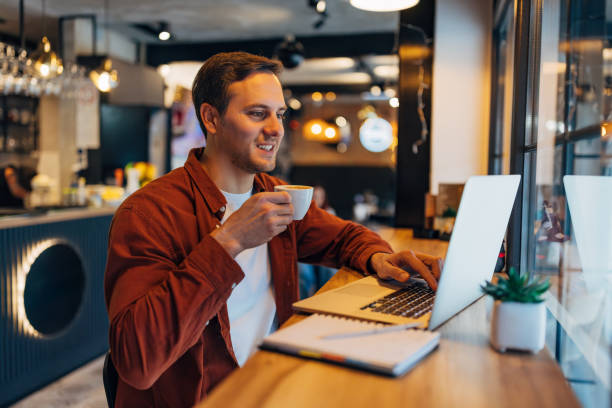 istock A male freelancer drinks his favorite espresso while working from a coffee shop, using a laptop 2191172353