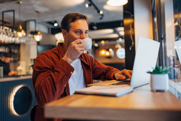 istock A male entrepreneur drinks his favorite espresso while working from a coffee shop, using a laptop 2191172355