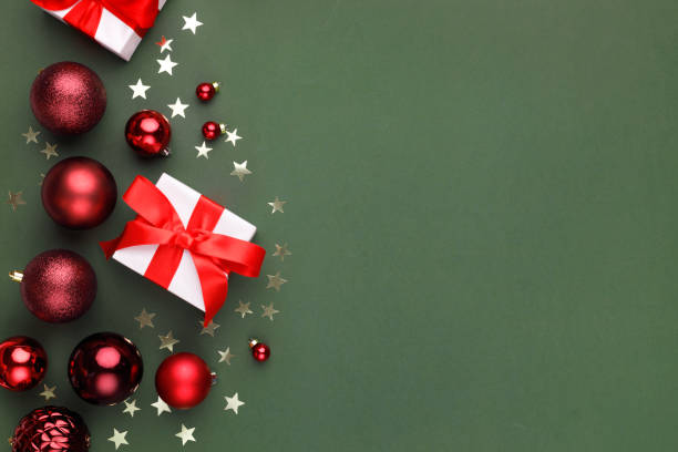 istock Christmas holiday background. Gift boxes and red decorations on color background 2191172654