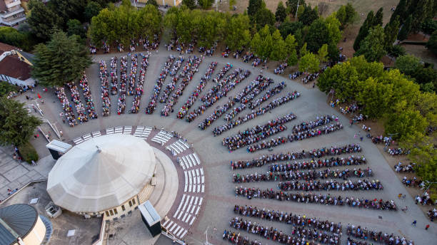 istock Aerial view crowd of people sitting in semicircle 2191173421