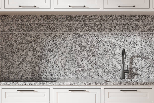 istock Granite kitchen countertop and backsplash with white cabinets and modern faucet. 3D Rendering 2191175070