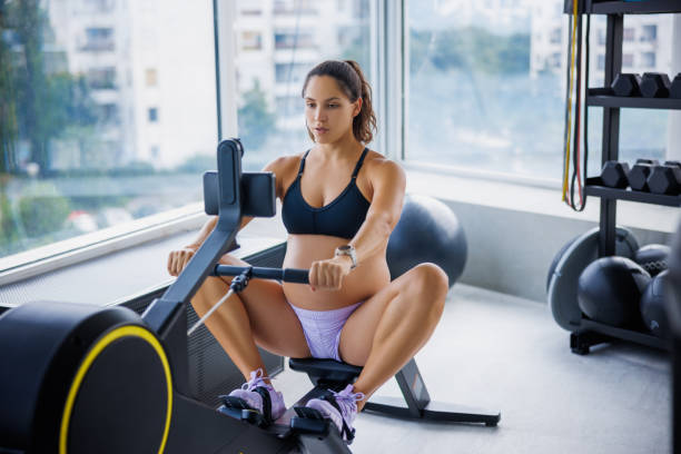 istock Beautiful pregnant woman using exercise machine in the gym 2191175288